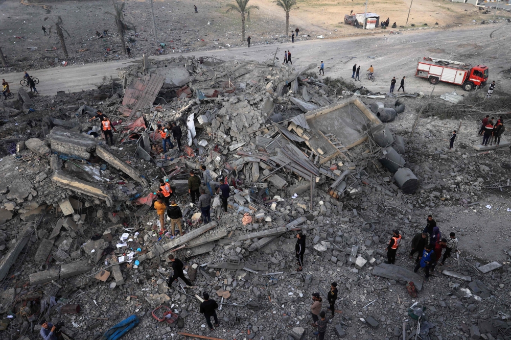 Palestinians check the rubble following Israeli strikes in Rafah in the southern Gaza Strip