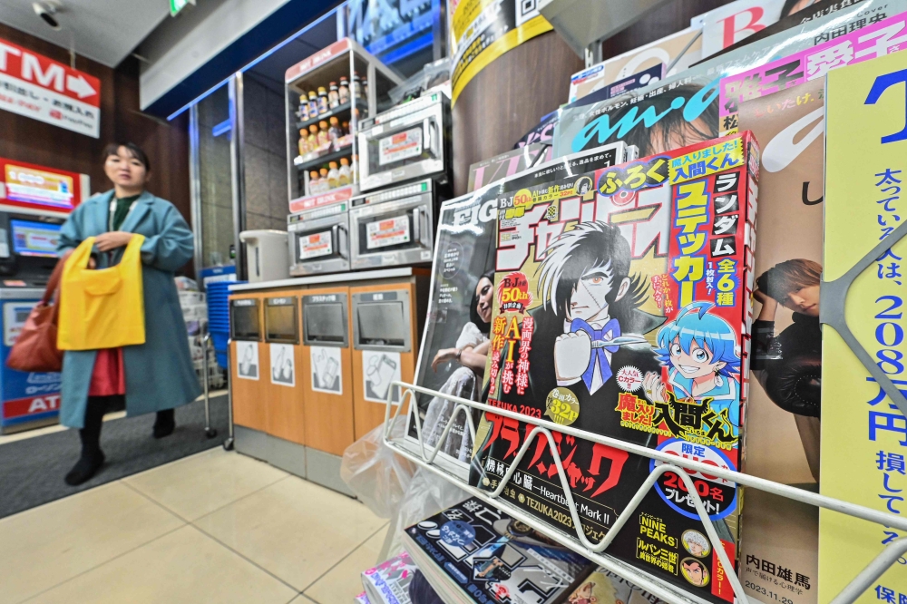 A magazine rack with the newest installment of a hugely successful Japanese manga series "Black Jack" (front R) created by the pioneering Osamu Tezuka, in Tokyo on Wednesday. — AFP
