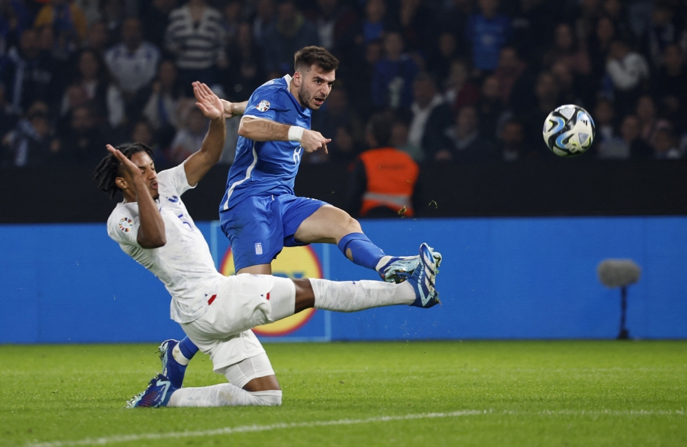 Soccer Football - UEFA Euro 2024 qualifier - Group B - Greece v France - OPAP Arena, Athens, Greece - November 21, 2023 Greece's Andreas Bouchalakis in action with France's Jules Kounde REUTERS/Louisa Gouliamaki