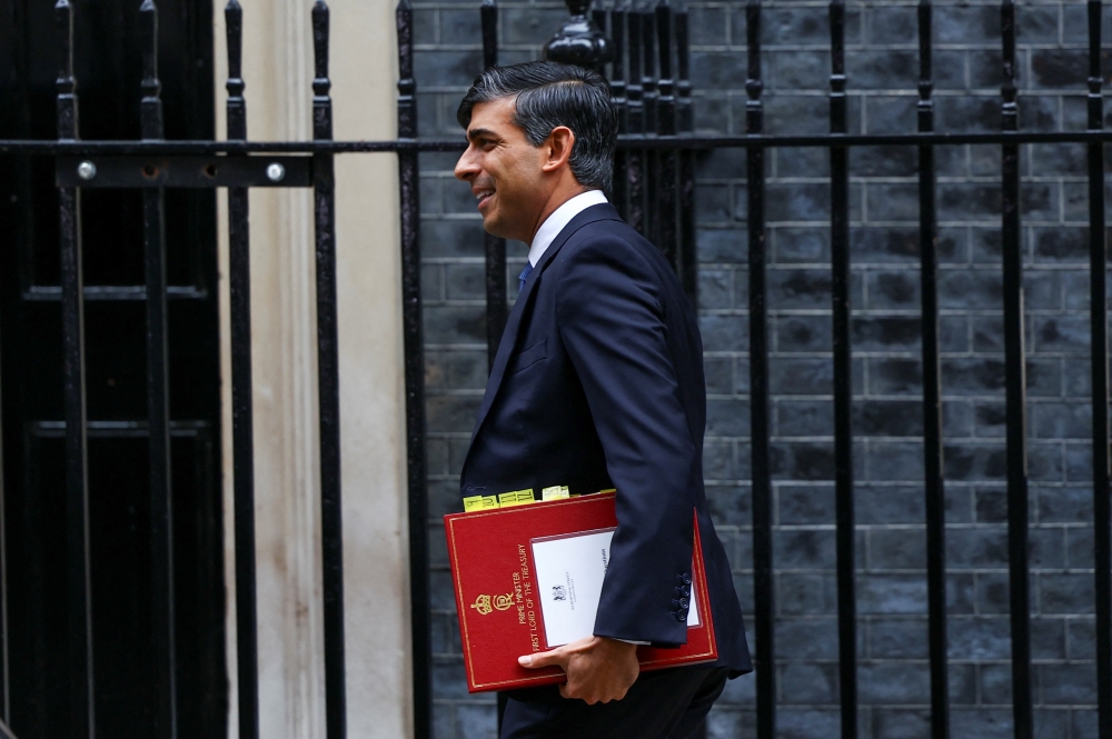 Britain's Prime Minister Rishi Sunak walks outside Downing Street in London. - Reuters

