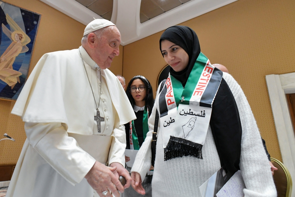 Pope Francis meets with Palestinians whose relatives are stranded in Gaza at the Vatican. - Reuters
