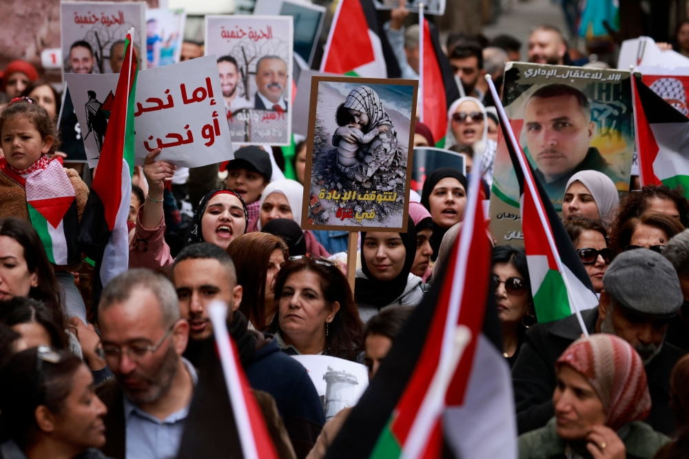 Palestinians march to express their solidarity with the Gaza Strip in the occupied West Bank city of Ramallah. - AFP 
