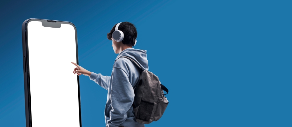 Student interacting with a big touch screen smartphone blank display