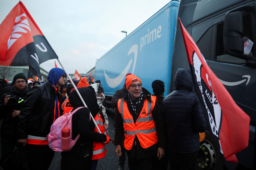 Protestors stand next to a lorry of Amazon during a Black Friday strike outside the Amazon warehouse in Coventry, Britain. - Reuters 
