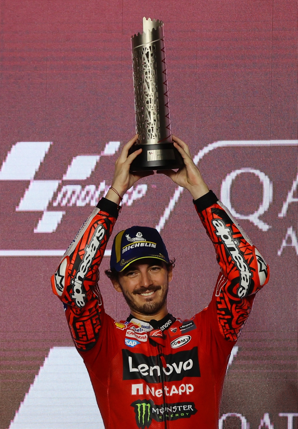 Grand Prix of Qatar - Lusail International Circuit, Lusail, Qatar - November 19, 2023  Ducati Lenovo Team's Francesco Bagnaia celebrates with a trophy on the podium after finishing second place in the Grand Prix of Qatar REUTERS/Ibraheem Al Omari