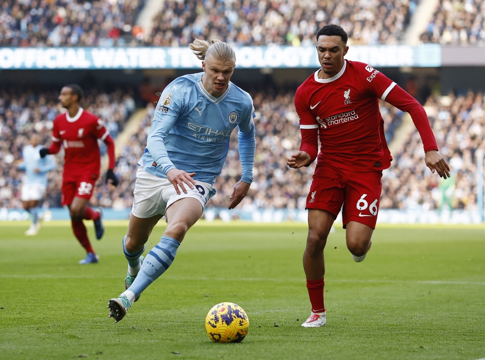 Manchester City's Erling Braut Haaland in action with Liverpool's Trent Alexander-Arnold. — Reuters
