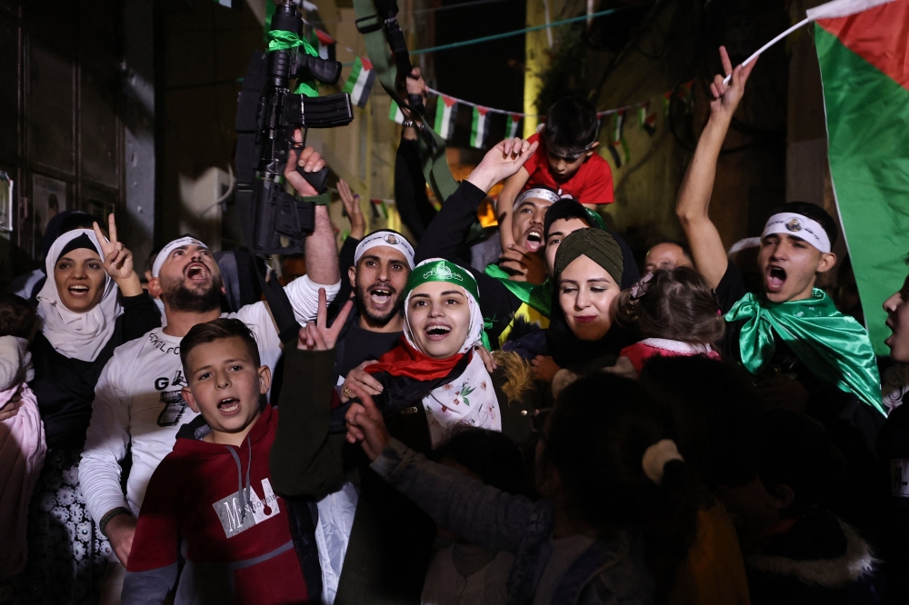 Asil al-Titi, a 23-year-old woman from the occupied West Bank Balata refugee camp, is greeted by friends and family members, shortly after she was released from an Israeli jail. — AFP 