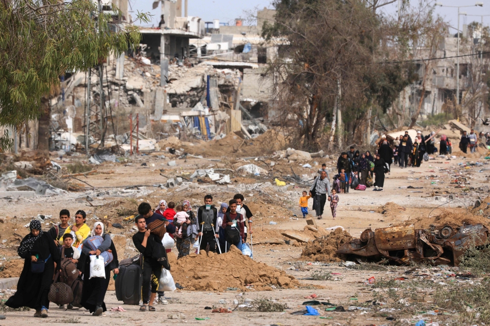 Palestinians leaving the north walk through the Salaheddine road in the Zeitoun district on the southern outskirts of Gaza City. — AFP 