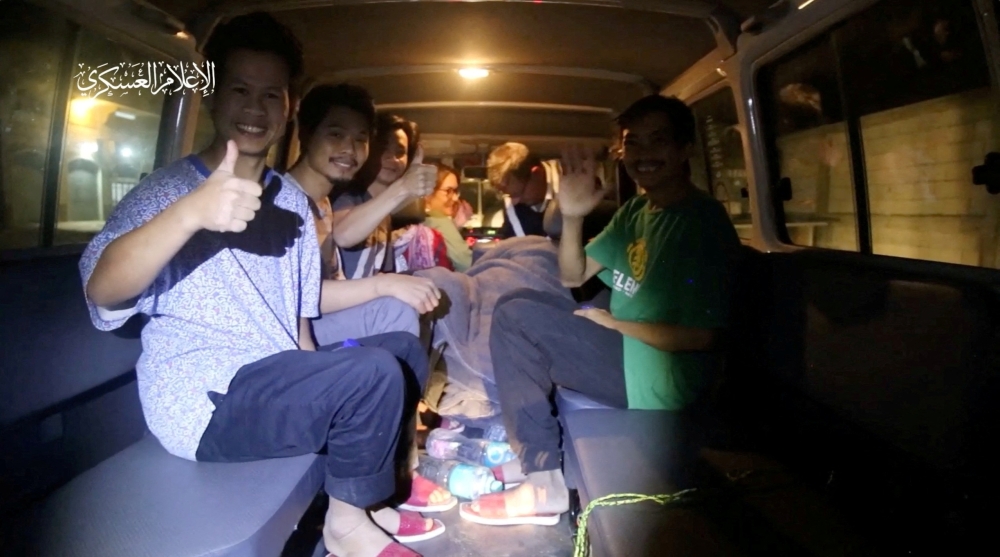 Hostages give a thumbs-up after their release