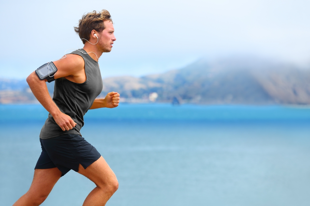 Running,App,On,Smartphone.,Male,Runner,Listening,To,Music,Jogging