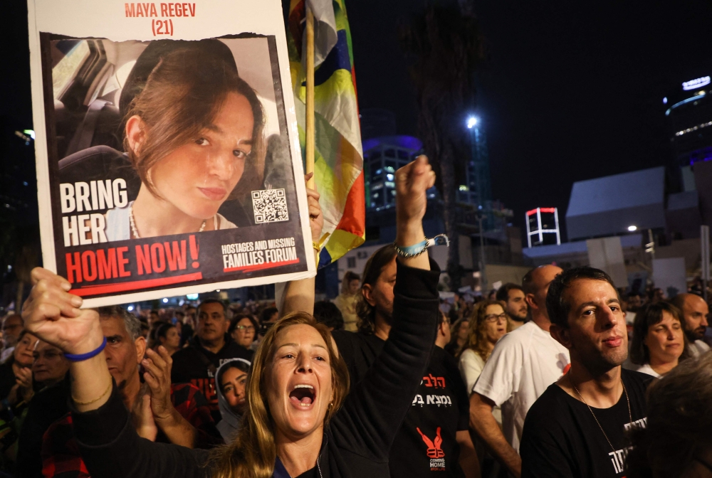 Relatives take part in a protest asking for the release of Israeli hostages in Tel Aviv. — AFP 