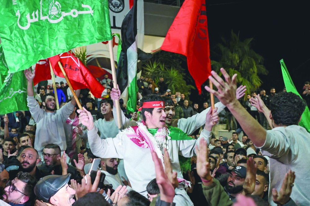 Palestinians cheer among supporters after being released from Israeli jails, in Ramallah in the occupied West Bank. — AFP