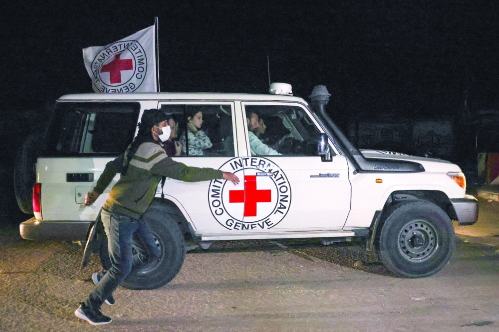 An International Red Cross vehicle reportedly carrying hostages released drives towards the Rafah border point with Egypt ahead of their transfer to Israel. — AFP