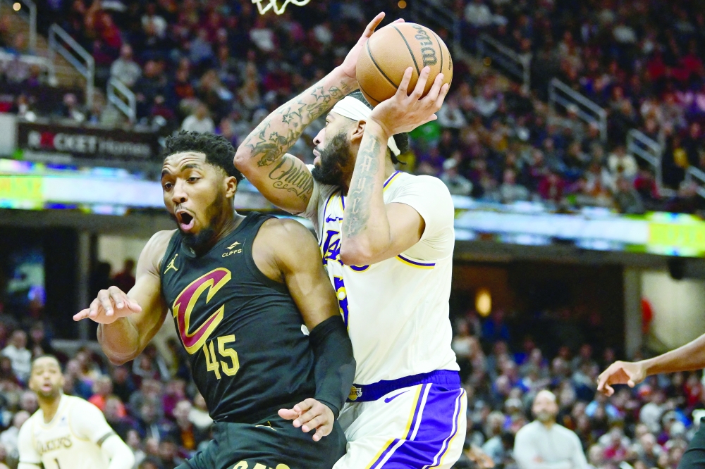 Anthony Davis (3) drives to the basket against Donovan Mitchell (45) at Rocket Mortgage FieldHouse. 