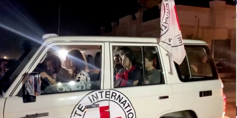 A vehicle carrying hostages abducted by Hamas militants during the October 7 attack on Israel arrives at the Rafah border