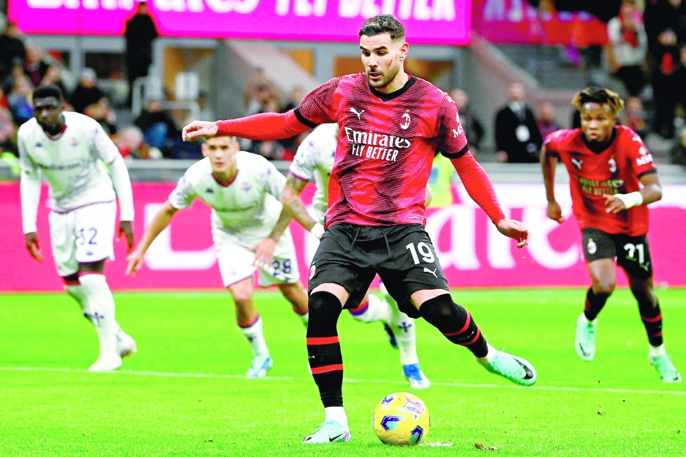 Theo Hernandez (C) kicks a penalty and scores his team's first goal.— AFP

