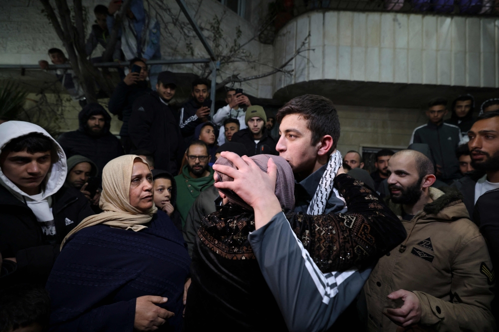 Palestinian Khalil Zama' hugs his mother after being released from a jail 