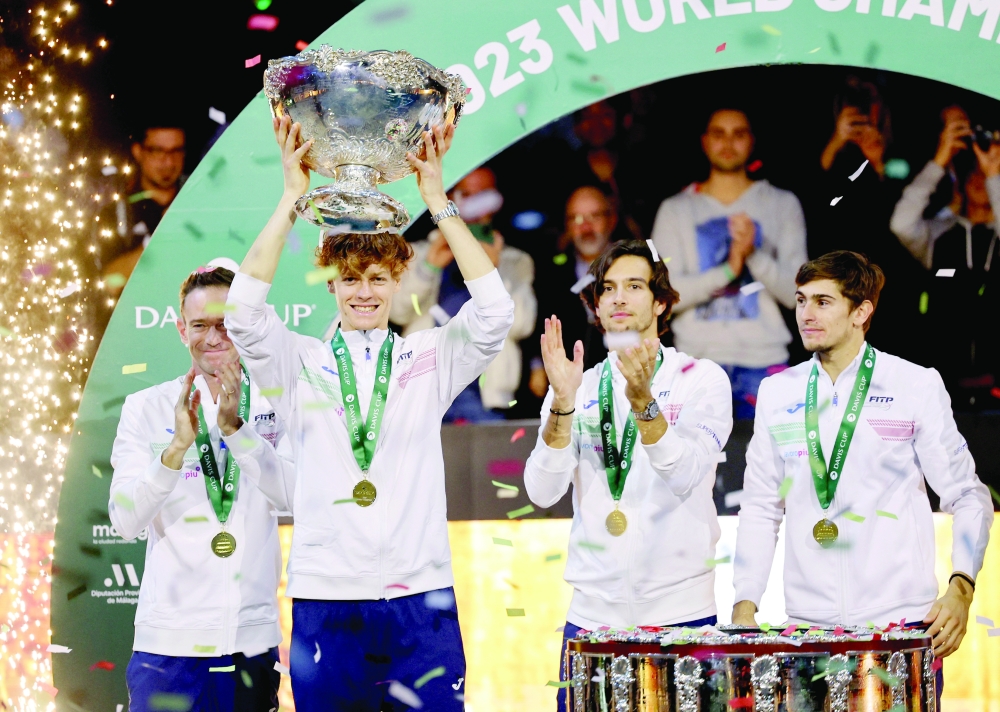 Italy's Jannik Sinner celebrates with the trophy and teammates after winning the Davis Cup.— Reuters