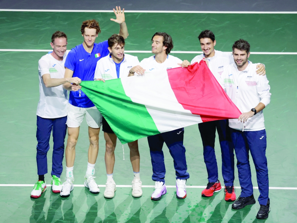 Italy's Jannik Sinner, Lorenzo Musetti, Matteo Arnaldi, Lorenzo Sonego, Simone Bolelli and captain Filippo Volandri celebrate after winning the Davis Cup. — Reuters
