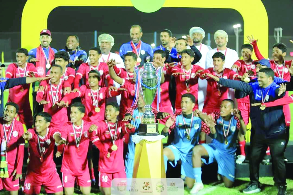 Oman National U-15 football team celebrating with the trophy