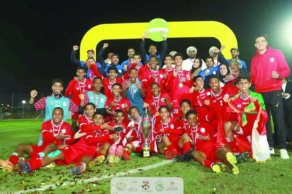 Oman National U-15 football team celebrating with the trophy