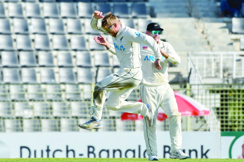 Glenn Phillips celebrate with Tom Latham during the first day of the first Test cricket match.—AFP

