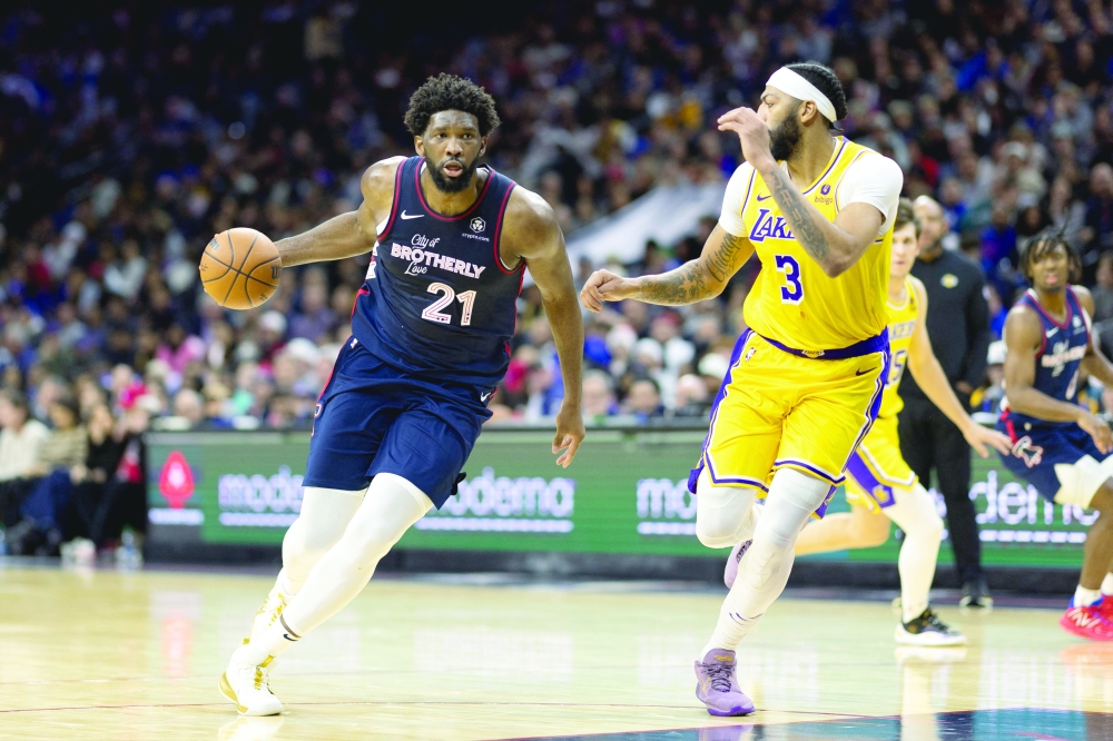 Joel Embiid (21) dribbles the ball against Anthony Davis (3) during the third quarter.— USA TODAY Sports
