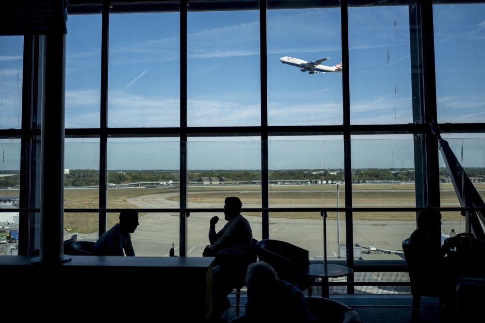  Passengers wait for their flights at Heathrow Airport's Terminal 5 in west London. — AFP file photo