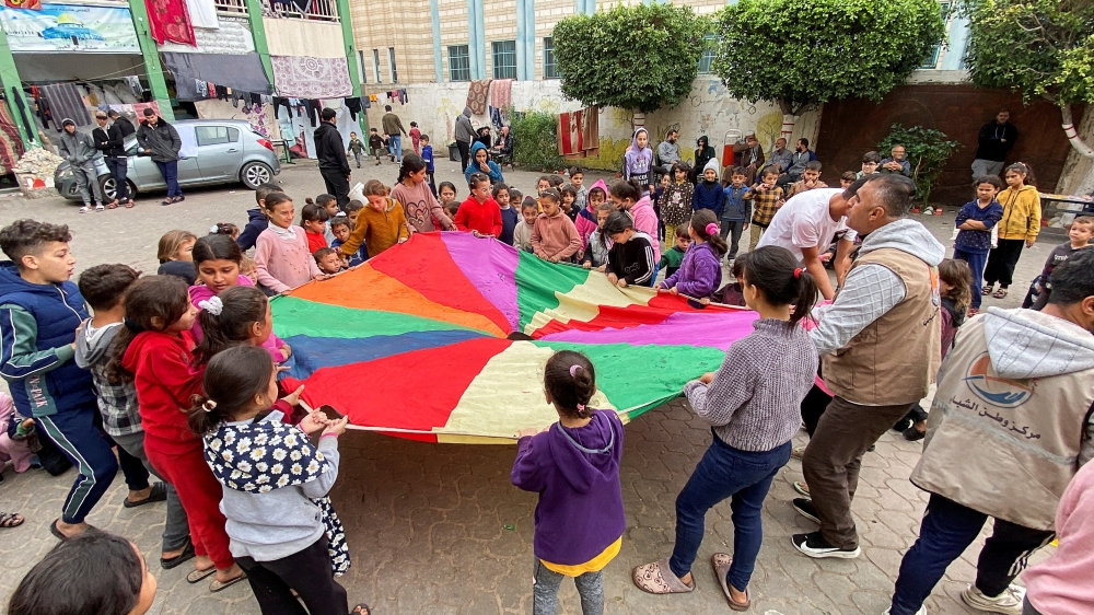 Displaced Palestinians participate in activity organized by volunteers to entertain and support mental health of children affected by the conflict, in Khan Younis on Tuesday. — Reuters