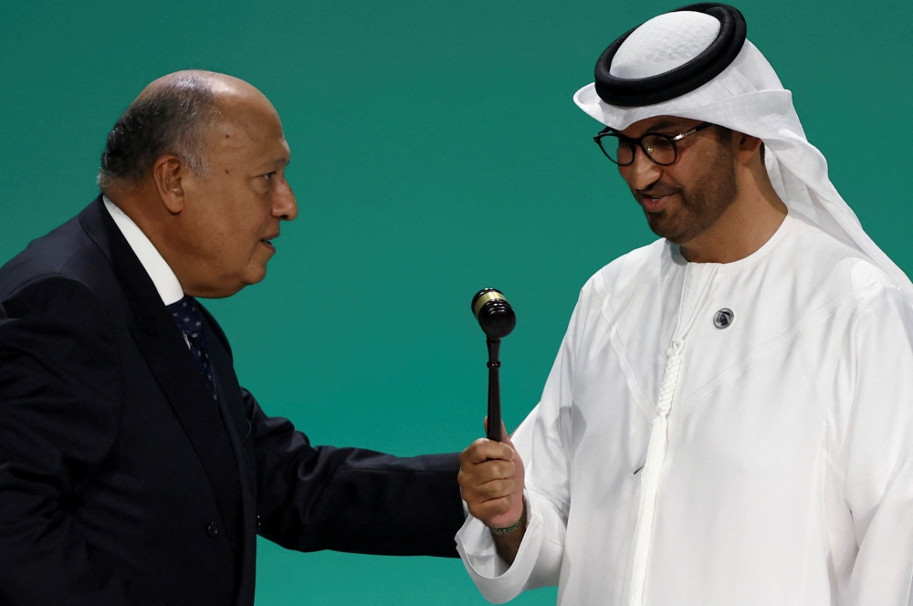United Arab Emirates Minister of Industry and Advanced Technology and COP28 President Sultan Ahmed Al Jaber receives a gavel from Egyptian Foreign Minister and COP27 President Sameh Shoukry during the United Nations Climate Change Conference (COP28) opening in Dubai on Thursday. — Reuters