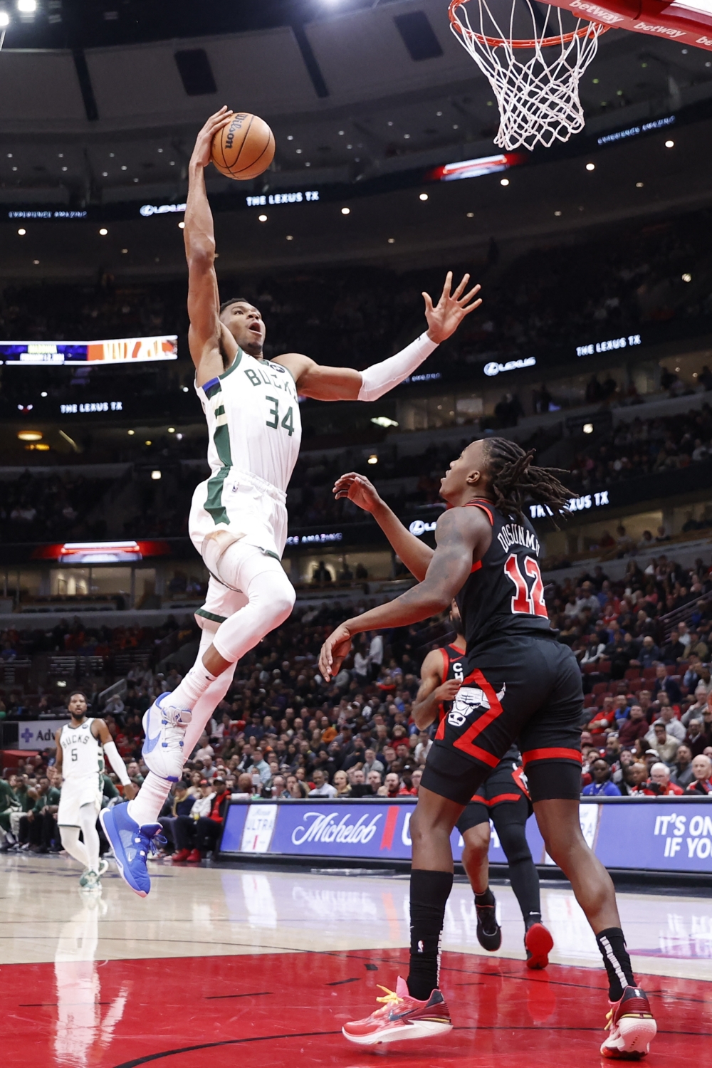 Nov 30, 2023; Chicago, Illinois, USA; Milwaukee Bucks forward Giannis Antetokounmpo (34) goes to the basket against Chicago Bulls guard Ayo Dosunmu (12) during the first half at United Center. Mandatory Credit: Kamil Krzaczynski-USA TODAY Sports
