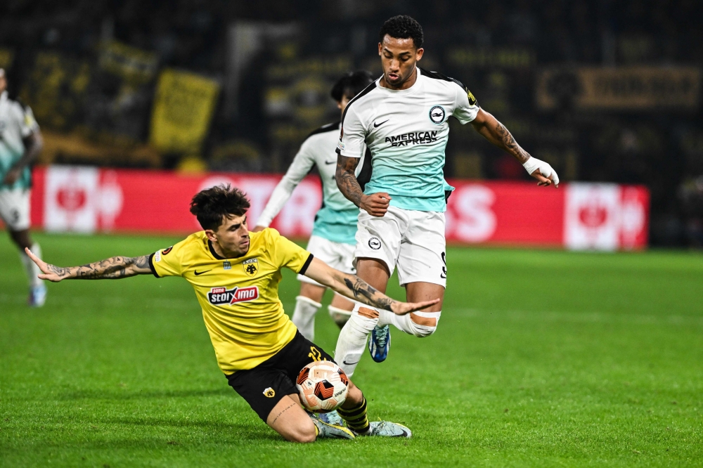 Brighton's Brazilian striker #09 Joao Pedro (R) fights for the ball with AEK's Greek defender #12 Lazaros Rota (L) during the UEFA Europa League Group B football match between AEK Athens FC and Brighton and Hove Albion FC at the Agia Sophia Stadium in Athens on November 30, 2023.  (Photo by Angelos TZORTZINIS / AFP)

