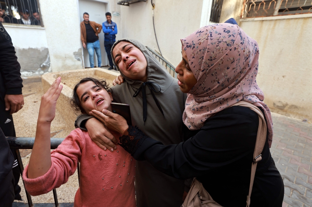 Family members mourn a baby girl killed in an Israeli strike in Rafah 