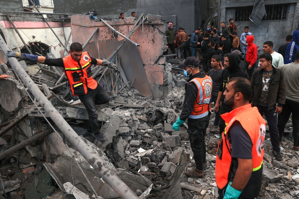 Palestinian medics search for survivors in the rubble of a building following Israeli bombardment in Rafah in the southern Gaza Strip. — AFP 