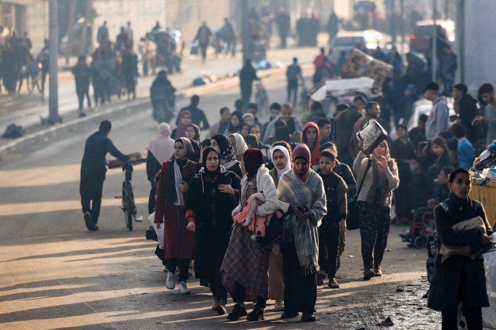 Palestinians walk toward safer areas following the resumption of Israeli strikes on Rafah in the southern Gaza Strip. — AFP 
