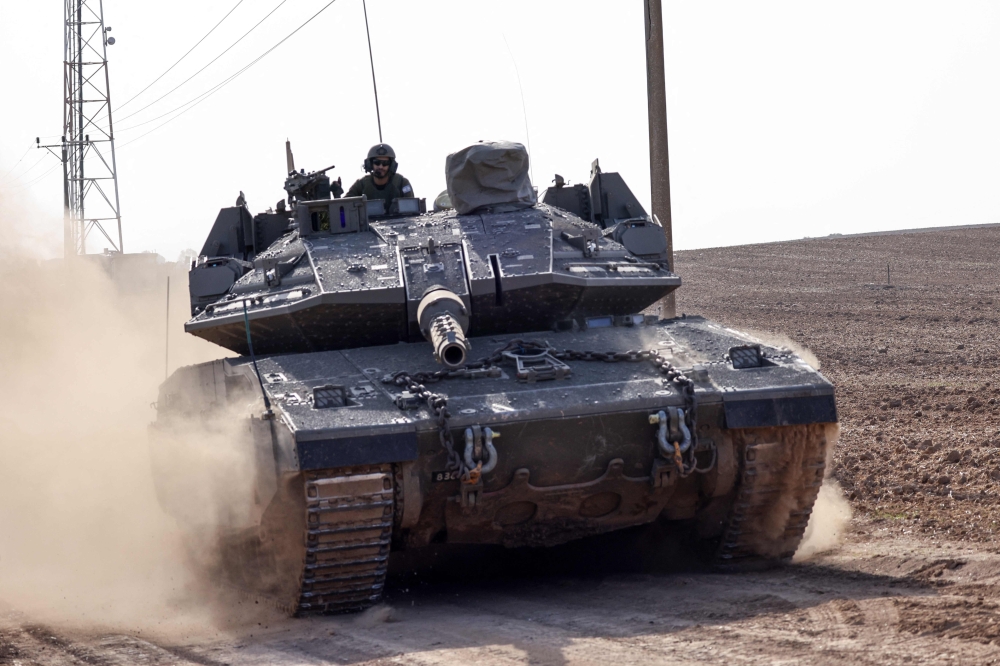 An Israeli tank rolls near the border with the Gaza Strip. — AFP 