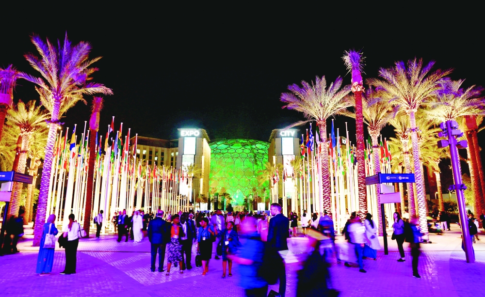 Delegates walk at Dubai's Expo City during the United Nations Climate Change Conference (COP28), in Dubai