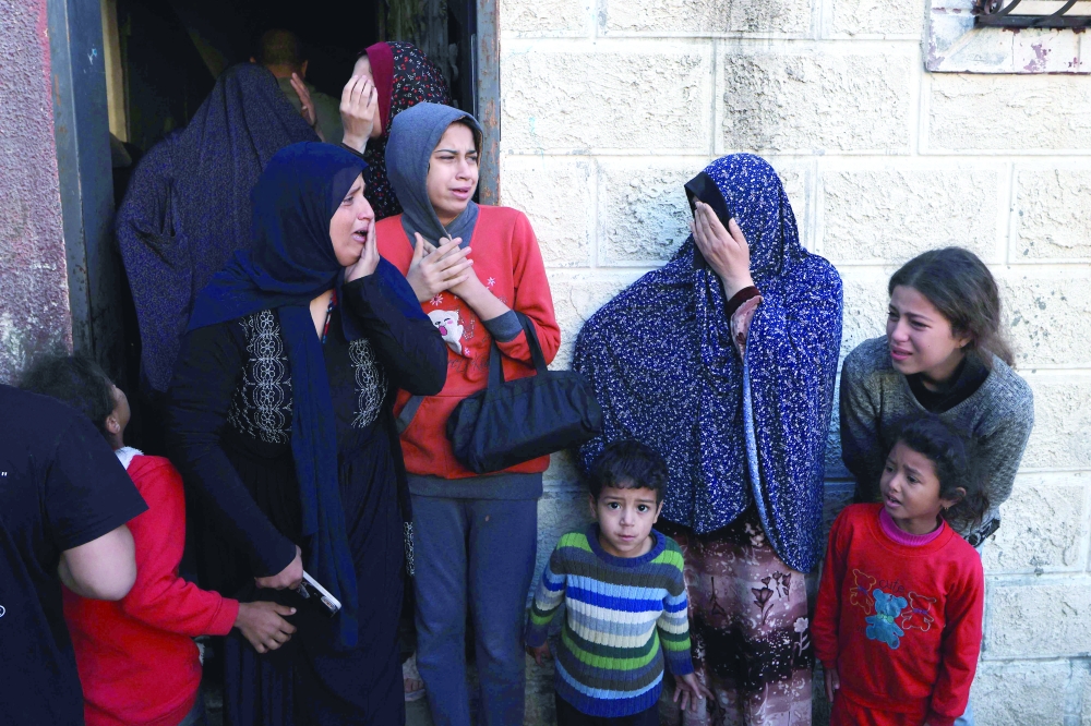 Women and children react after a house was hit by Israeli bombing in Khan Yunis in the southern Gaza Strip. — AFP 