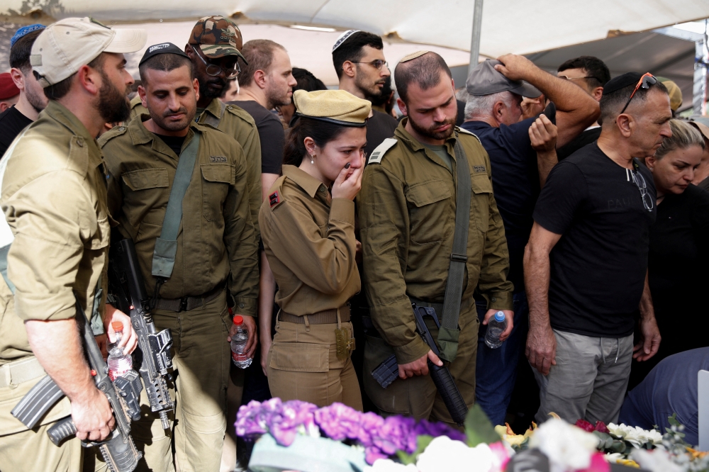Relatives mourn an Israeli soldier at his funeral in Tel Aviv. — Reuters