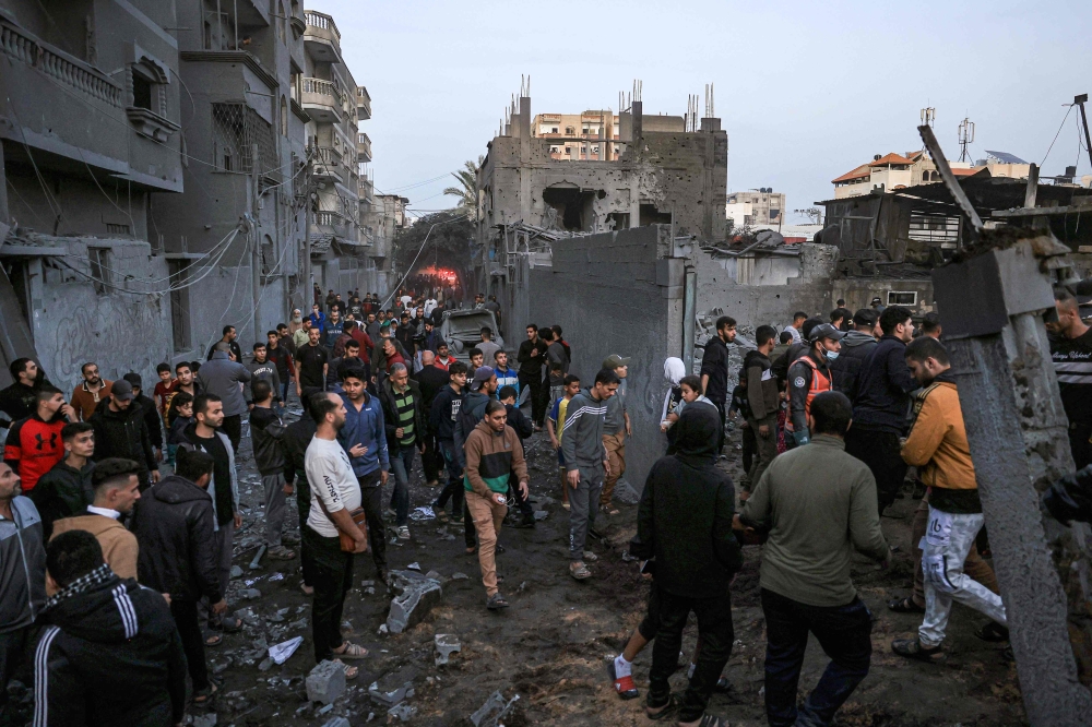 Palestinians check the damages after an Israeli strike in Rafah in the southern Gaza Strip. — AFP 