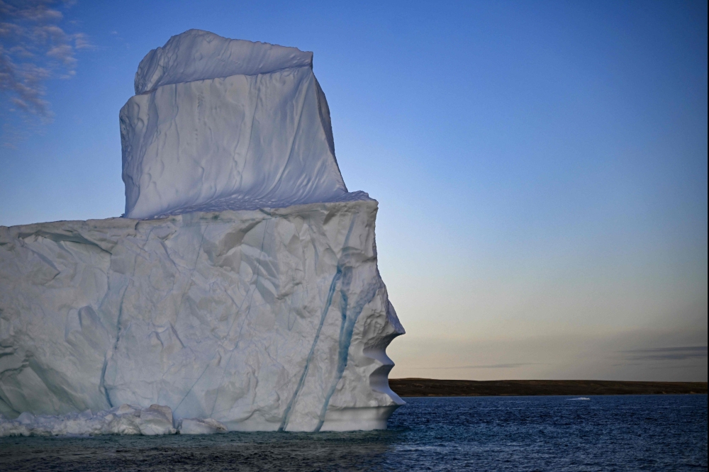 (FILES) A melting iceberg drifts due to high temperatures in Scoresby Fjord near Ittoqqortoormiit, Greenland