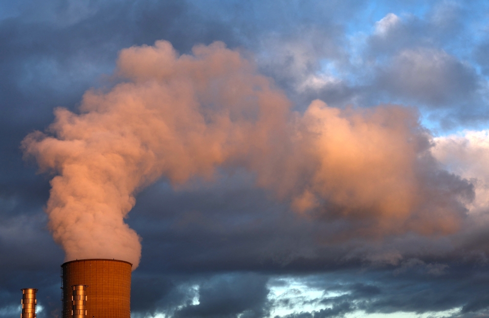Smoke billows from a chimney at a combined-cycle gas turbine power plant while coinciding the COP28 is being held in Dubai, in Drogenbos, Belgium December 6, 2023. REUTERS/Yves Herman
