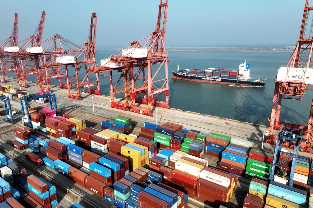 A cargo ship preparing to berth at the container terminal of Lianyungang Port in China. _AFP