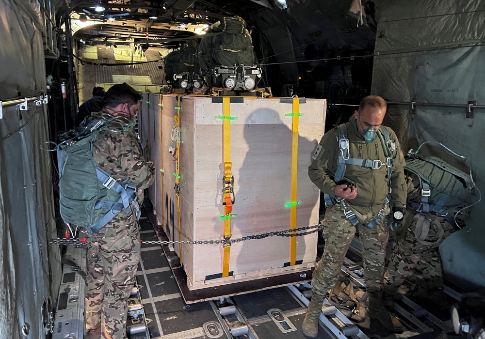 Members of the Jordanian Armed Forces wear oxygen masks as they prepare to airdrop medical aid destined to the Jordanian private field hospital in the southern Gaza city of Khan Younis. - Reuters

