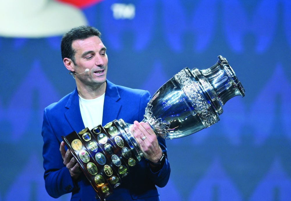 Argentina's coach Lionel Scaloni holds the Copa America trophy onstage during the final draw for the Conmebol Copa America 2024 football competition at the James L. Knight Centre in Miami, Florida, on December 7, 2023. (Photo by ANGELA WEISS / AFP)