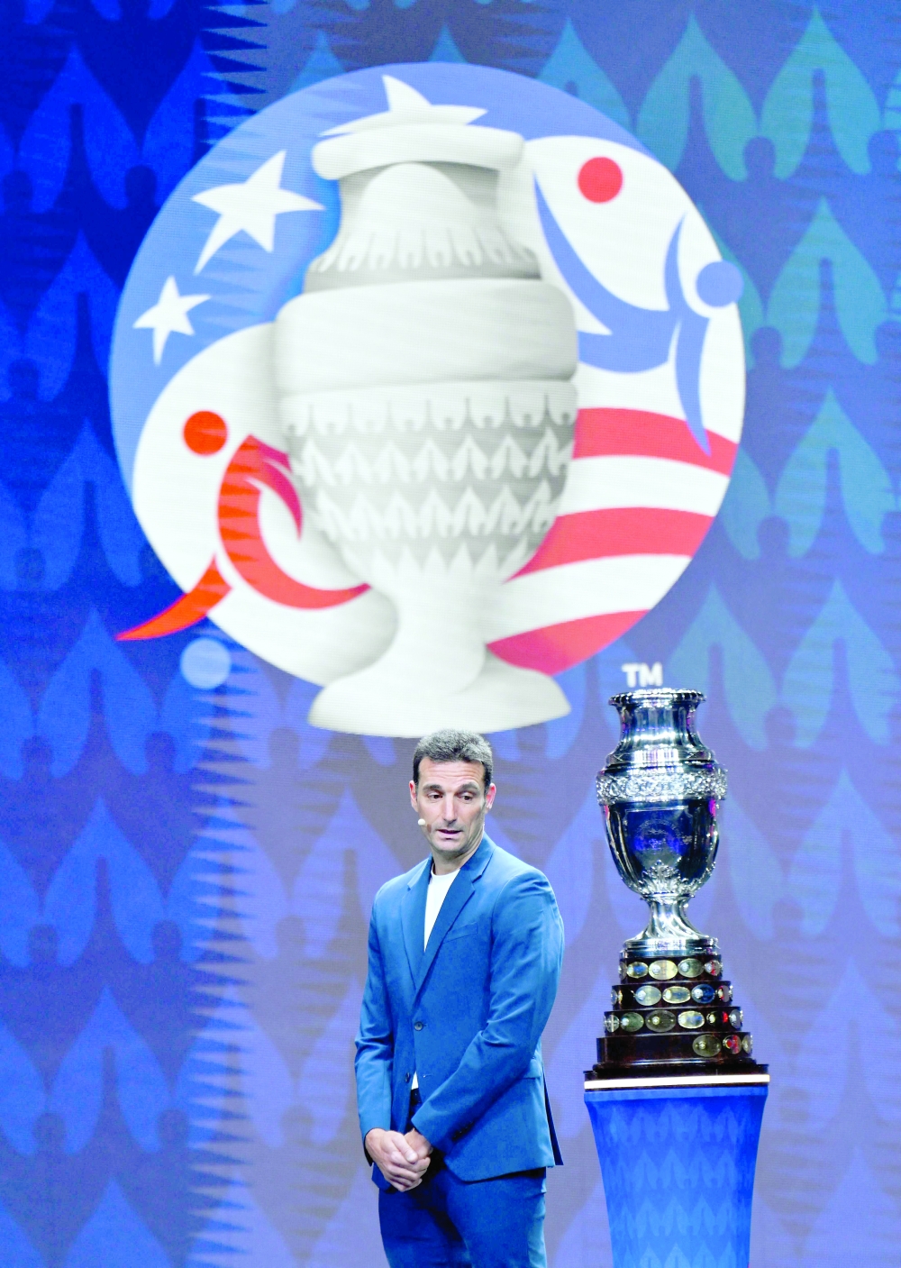 Argentina's coach Lionel Scaloni presents the Copa America trophy onstage during the final draw for the Conmebol Copa America 2024 football competition at the James L. Knight Centre in Miami, Florida, on December 7, 2023. (Photo by ANGELA WEISS / AFP)

