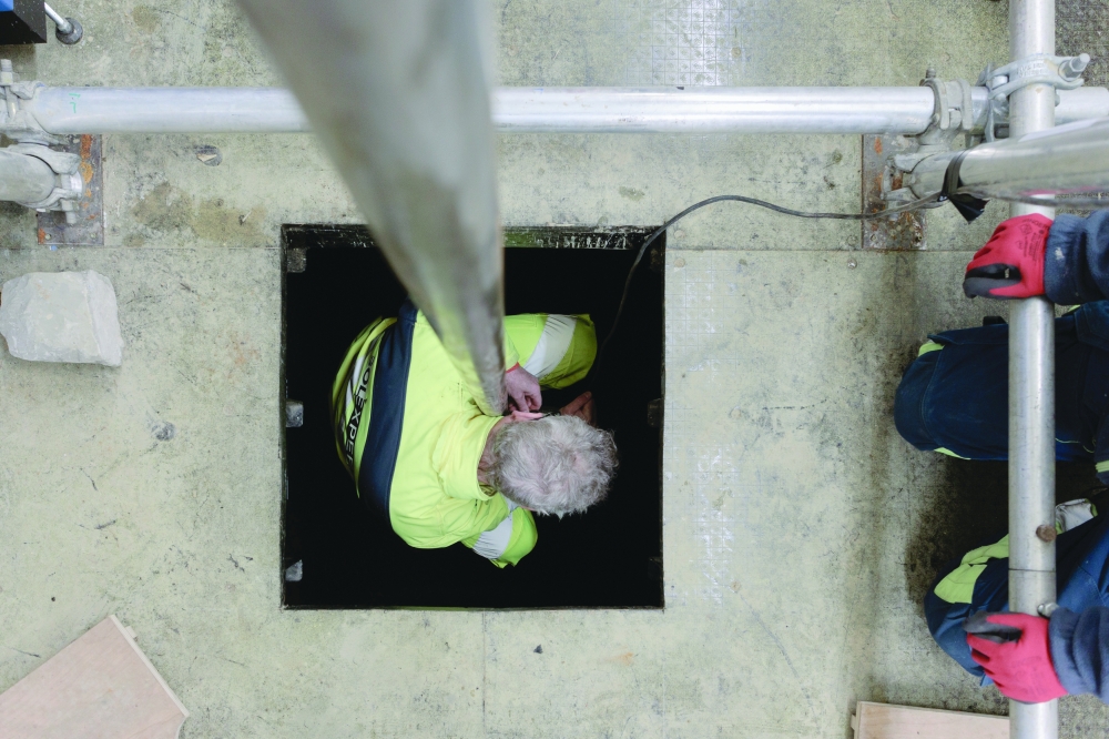 A worker detaches a probe that tests for hydrogen half a mile deep in the ground, in Folschviller, France. NYT