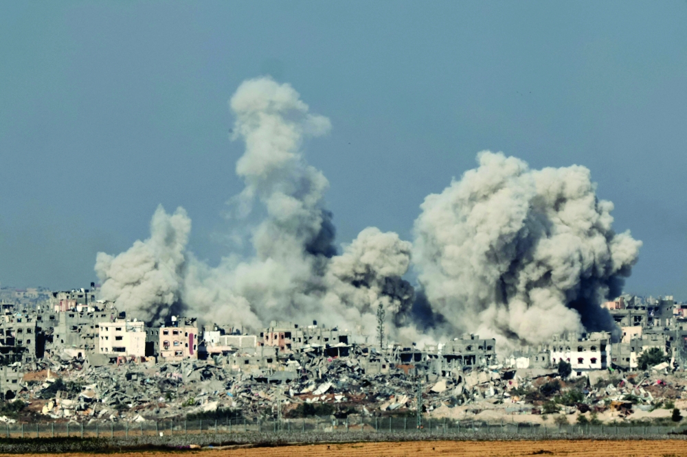 A picture shows smoke rising above buildings during an Israeli strike in northern Gaza. — AFP 