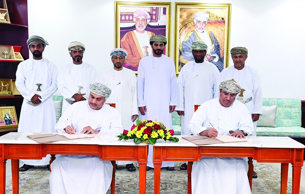 Officials sign the agreements on Sunday.