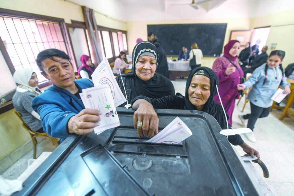 Egyptian women cast their ballot at a polling station of Shubra Secondary school in the presidential election in Cairo. - AFP
